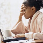 Upset Woman Using Laptop Woman sees mean comments online Using Laptop